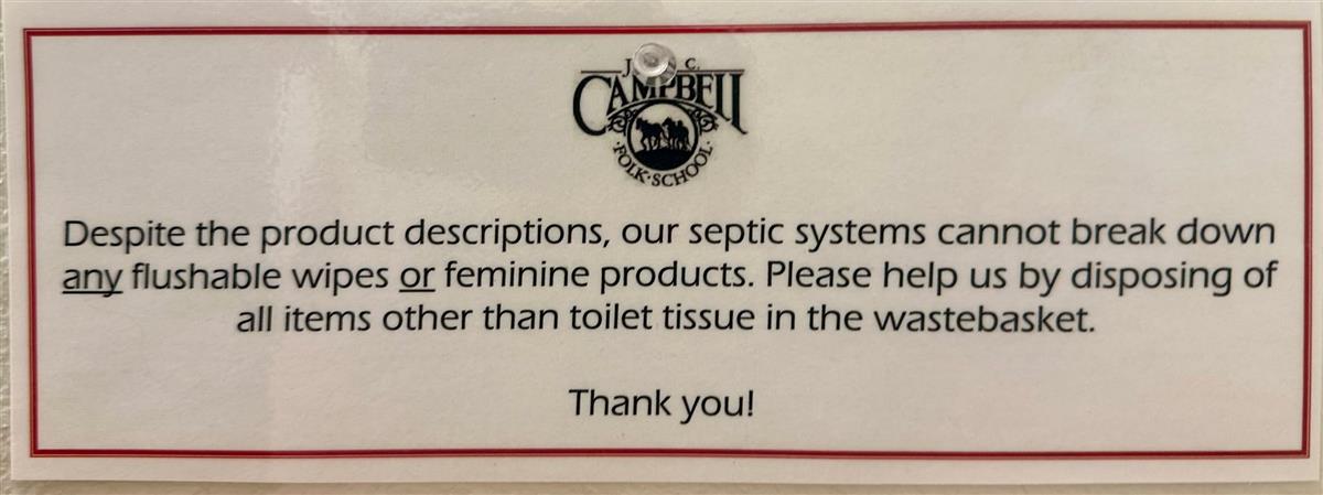 Campbell Folk School bathroom sign about flushable wipes